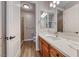 Bathroom features wood cabinets with a light countertop and shower with glass door at 2820 Sisteron Ct, Henderson, NV 89044