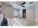 Comfortable staged bedroom with plush bedding, a ceiling fan, and closet at 2820 Sisteron Ct, Henderson, NV 89044
