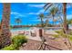 Inviting community pool area featuring palm trees, lounge chairs, and clear blue water under a sunny sky at 2820 Sisteron Ct, Henderson, NV 89044