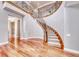 Elegant foyer with a winding staircase, hardwood floors, and wrought iron railing at 2820 Sisteron Ct, Henderson, NV 89044