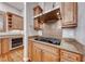 Well-equipped kitchen with granite countertops, a stainless range hood and matching appliances at 2820 Sisteron Ct, Henderson, NV 89044