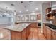 Kitchen with a central island, hardwood floors, granite counters, and stainless steel appliances at 2820 Sisteron Ct, Henderson, NV 89044