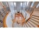 View from the winding staircase overlooking the bright living room with hardwood floors at 2820 Sisteron Ct, Henderson, NV 89044