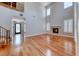 Expansive living room featuring soaring ceilings, a cozy fireplace, and elegant hardwood flooring at 2820 Sisteron Ct, Henderson, NV 89044