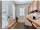 Home office with custom built-ins, wood floors, and natural light from the shuttered windows at 2820 Sisteron Ct, Henderson, NV 89044