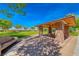 Picturesque outdoor pavilion with stone pillars, a seating area, and a view of the lush green lawns at 2820 Sisteron Ct, Henderson, NV 89044