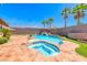 Sparkling pool and spa with rock features and a spacious patio, perfect for relaxing or entertaining outdoors at 2820 Sisteron Ct, Henderson, NV 89044
