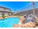 Enjoy the custom pool with rock slide, and a nearby cabana, great for entertaining in this luxurious backyard at 2820 Sisteron Ct, Henderson, NV 89044