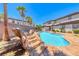 Backyard oasis featuring a custom pool with rock waterfall feature and ample patio space surrounded by desert landscaping at 2820 Sisteron Ct, Henderson, NV 89044