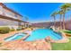 Resort-style pool with a spa and waterfall feature, surrounded by lush landscaping and a spacious patio area at 2820 Sisteron Ct, Henderson, NV 89044