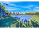 Outdoor tennis courts with blue playing surface surrounded by green, tall fencing, and bright overhead lighting at 2820 Sisteron Ct, Henderson, NV 89044