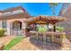 Backyard tiki bar with seating and built-in grill at 2820 Sisteron Ct, Henderson, NV 89044