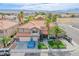 Beautiful aerial view of the home featuring a red tile roof, palm trees, and landscaping at 3617 Dutch Valley Dr, Las Vegas, NV 89147