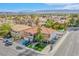 This home features a red tile roof, lush landscaping, a two-car garage, and mountain views at 3617 Dutch Valley Dr, Las Vegas, NV 89147