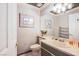 Neutral bathroom features a framed mirror, a single sink vanity, decor and functional storage space at 3617 Dutch Valley Dr, Las Vegas, NV 89147