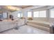 Bright primary bathroom with double sinks, a large soaking tub, and tile flooring at 3617 Dutch Valley Dr, Las Vegas, NV 89147