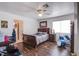 The well-lit bedroom offers a ceiling fan, a bed, blue drums, and convenient access to an adjacent space at 3617 Dutch Valley Dr, Las Vegas, NV 89147