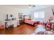 Bright bedroom features a bed, a vanity area, wood floors, ample natural light, and fun cartoon artwork at 3617 Dutch Valley Dr, Las Vegas, NV 89147