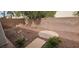 A backyard features a brick retaining wall, decorative rock, landscaping, and a hardscape area at 3750 Morning Canyon St, Las Vegas, NV 89147