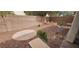 A backyard features a brick retaining wall, decorative rock, landscaping, and a hardscape area at 3750 Morning Canyon St, Las Vegas, NV 89147