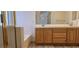 A bathroom with a double sink vanity, bathtub with glass door, and ample lighting at 3750 Morning Canyon St, Las Vegas, NV 89147