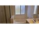 Bathroom featuring a bathtub, white tile, and a window with a view at 3750 Morning Canyon St, Las Vegas, NV 89147