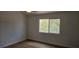 A cozy bedroom featuring wood floors and a window offering natural light at 3750 Morning Canyon St, Las Vegas, NV 89147
