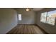 A spacious bedroom featuring wood floors, a ceiling fan, and ample natural light from a window at 3750 Morning Canyon St, Las Vegas, NV 89147