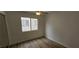 Bedroom with wood-look floors, a ceiling fan, and a large window at 3750 Morning Canyon St, Las Vegas, NV 89147
