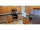 Updated kitchen featuring stainless steel appliances, granite countertops, and wood cabinetry at 3750 Morning Canyon St, Las Vegas, NV 89147