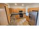 This kitchen features wood cabinets, stainless steel appliances, granite counters, and a stainless sink at 3750 Morning Canyon St, Las Vegas, NV 89147