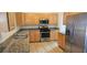 Updated kitchen featuring stainless steel appliances, granite countertops, and wood cabinetry at 3750 Morning Canyon St, Las Vegas, NV 89147