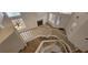 Bright living room with fireplace, staircase, wood floors, and natural light from multiple windows at 3750 Morning Canyon St, Las Vegas, NV 89147
