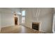 Bright living room featuring a fireplace, hardwood floors, and large windows at 3750 Morning Canyon St, Las Vegas, NV 89147