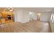 Open floor plan with eat in kitchen, white walls and staircase with natural light at 3750 Morning Canyon St, Las Vegas, NV 89147