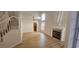 Open-concept living room with a fireplace and hardwood floors next to the stair case at 3750 Morning Canyon St, Las Vegas, NV 89147