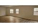 Spacious living room with light wood laminate floors and windows with natural light at 3750 Morning Canyon St, Las Vegas, NV 89147