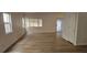 Spacious living room with light wood laminate floors and windows with natural light at 3750 Morning Canyon St, Las Vegas, NV 89147
