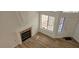 Bright living room with fireplace, wood floors, and natural light from large windows at 3750 Morning Canyon St, Las Vegas, NV 89147