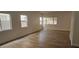 Spacious living room with light wood laminate floors and multiple windows with natural light at 3750 Morning Canyon St, Las Vegas, NV 89147