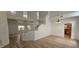 Spacious living room with open stairs and hardwood floors leading to the kitchen at 3750 Morning Canyon St, Las Vegas, NV 89147