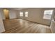 Spacious living room with light wood laminate floors and windows with natural light at 3750 Morning Canyon St, Las Vegas, NV 89147