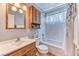 Cozy bathroom with a single sink, wooden vanity, and tub-shower combo at 4381 Toledo Ave, Las Vegas, NV 89121