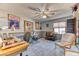 Spacious bedroom with comfortable seating and a ceiling fan at 4381 Toledo Ave, Las Vegas, NV 89121