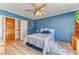 Comfortable bedroom with a ceiling fan and laminate wood flooring at 4381 Toledo Ave, Las Vegas, NV 89121