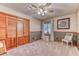 Comfortable bedroom with a ceiling fan and carpet flooring at 4381 Toledo Ave, Las Vegas, NV 89121