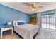 Comfortable bedroom with a ceiling fan and sliding glass doors to the backyard at 4381 Toledo Ave, Las Vegas, NV 89121