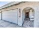 Inviting front entrance with an arched doorway and garage at 4381 Toledo Ave, Las Vegas, NV 89121