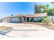 Charming single-story home featuring a two-car garage, desert landscaping, and a welcoming front entrance at 4381 Toledo Ave, Las Vegas, NV 89121