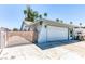 Charming single-story home featuring a two-car garage, desert landscaping, and a welcoming front entrance at 4381 Toledo Ave, Las Vegas, NV 89121